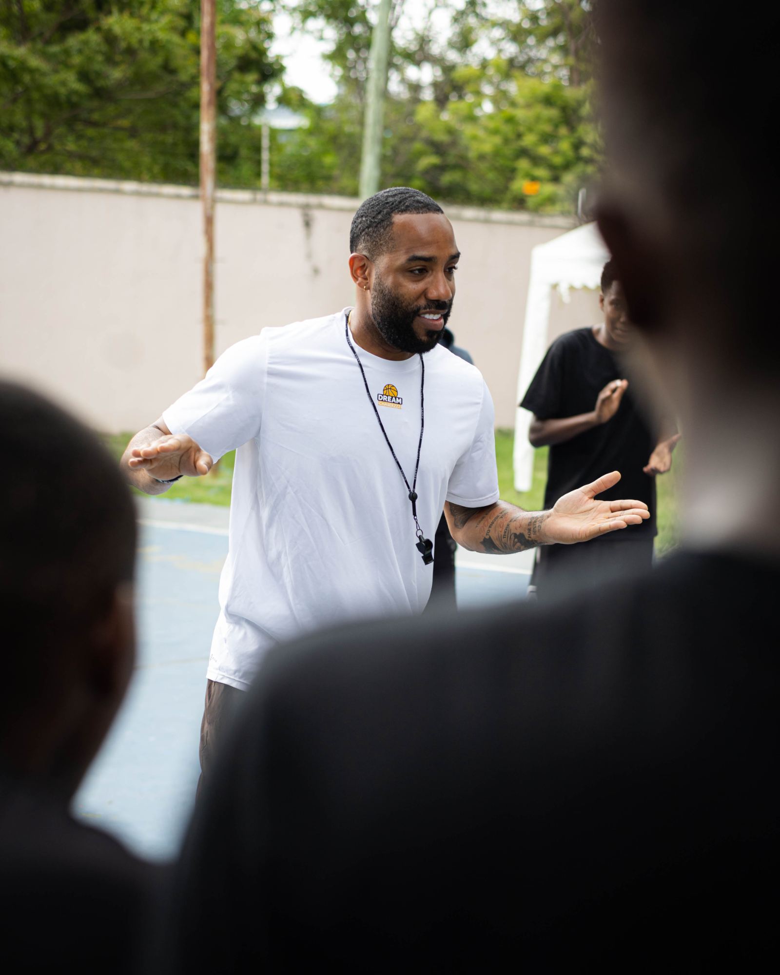 Coach speaking with athletes during a camp session