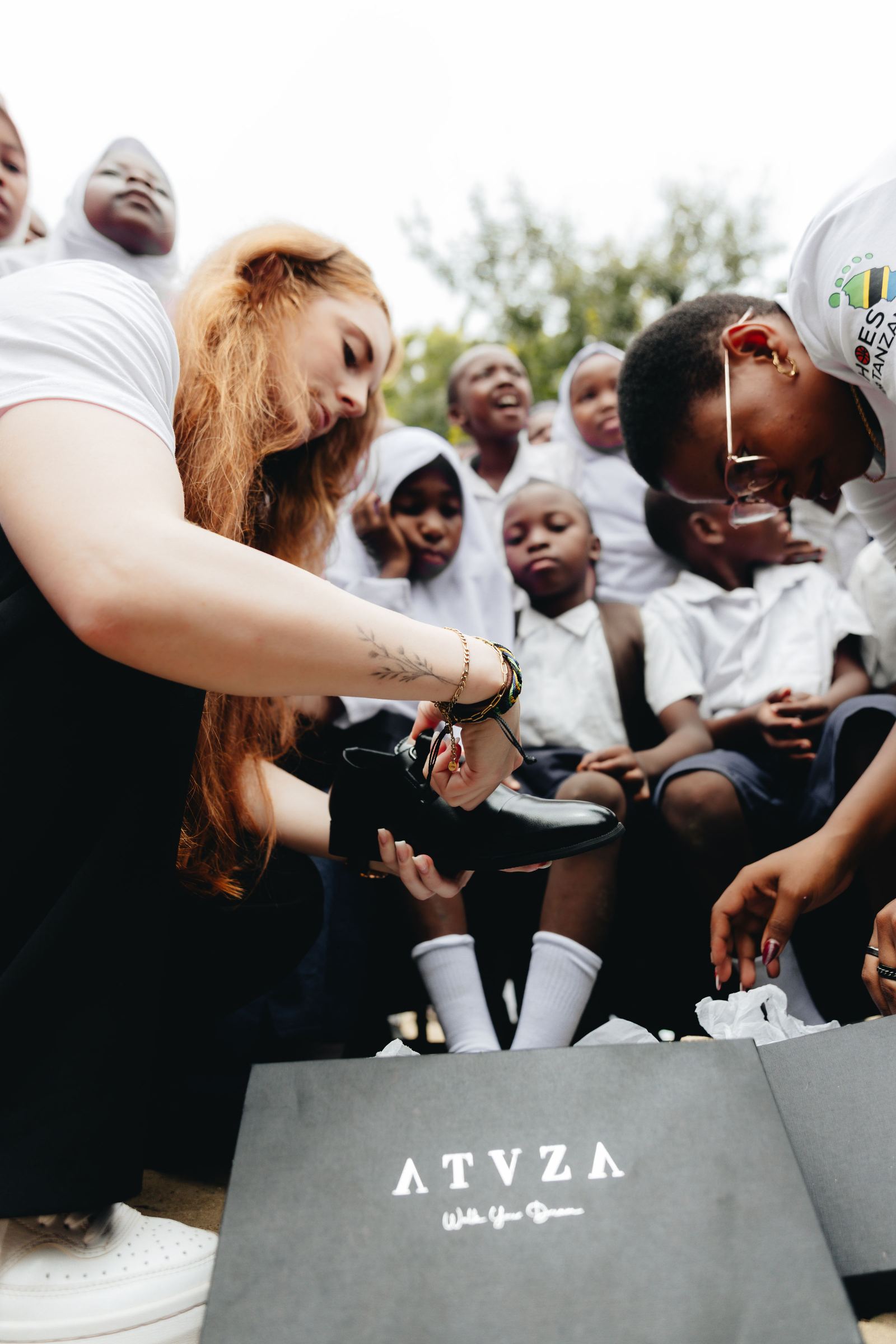 A student trying on new school shoes during the 2026 distribution