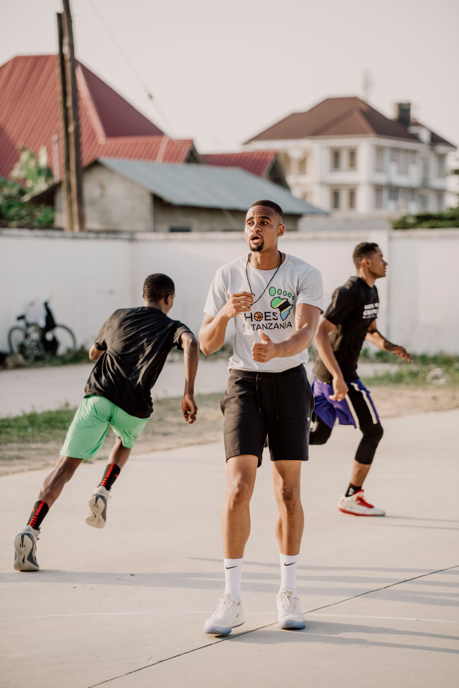 Alpha Kisusi on an outdoor court